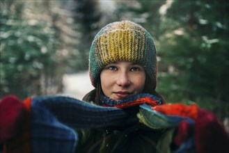 Teenage girl with colorful woollen hat and scarf during winter