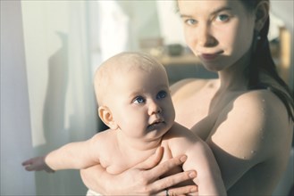 Baby being held by her mother