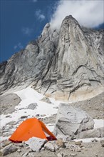 Orange tent in Purcell Mountains, Bugaboo Provincial Park, British Columbia, Canada
