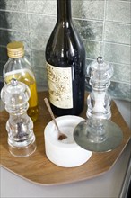 Oil, salt and pepper on tray in kitchen