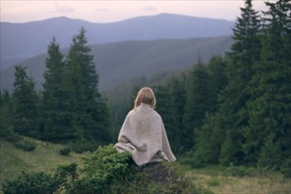 Woman wrapped in blanket in the Carpathian Mountain Range