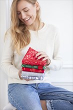 Smiling woman holding Christmas fabrics