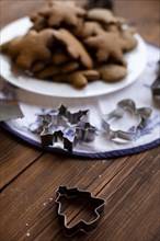 Cookie cutters by plate of Christmas cookies