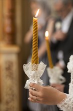 Hand of bride holding candle at wedding
