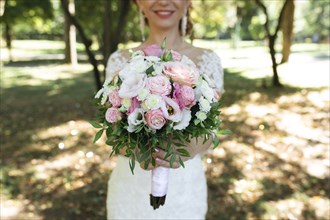 Hands of bride holding bouquet