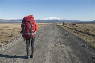 Hiker on road in Fjallabak Nature Reserve in Iceland