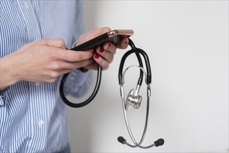 Doctor holding stethoscope and smart phone