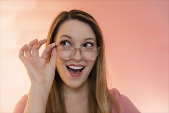 Excited young woman wearing glasses