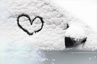Heart drawn in snow on car window