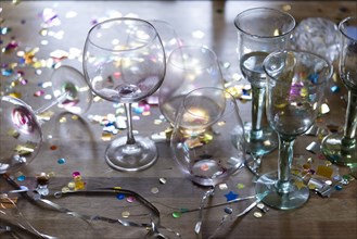 Empty wineglasses with confetti