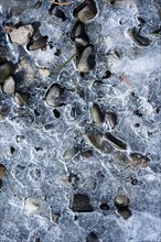 Ice over pebbles
