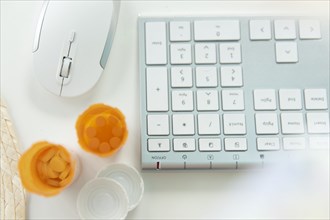 Open pill bottles by computer keyboard and mouse