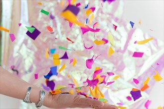Woman's hand throwing confetti