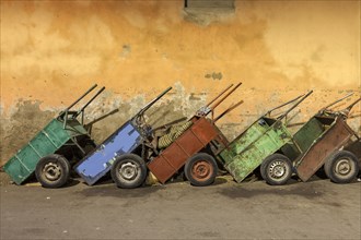 Row of carts against weathered wall