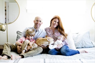 Family and their dog on bed