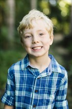 Portrait of smiling boy wearing checked shirt