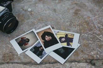 Polaroid photographs of young woman by camera