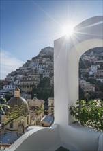 Sunbeam over whitewash arch in Positano on Amalfi Coast, Italy