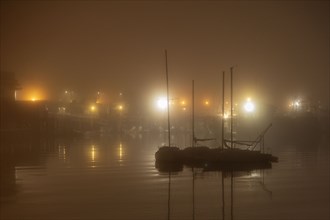 Moored sailboats at night