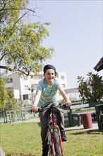 Teenage boy cycling in park