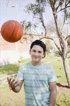 Teenage boy throwing basketball