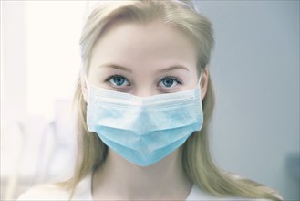 Portrait of young woman wearing surgical mask