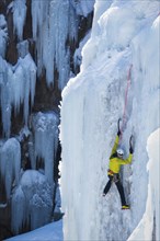 Man ice climbing in Ouray, USA
