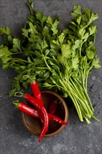 Parsley with chili peppers in bowl