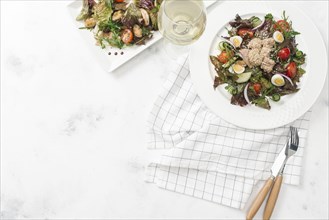 Plate of salad with white wine