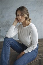 Young woman wearing white sweater