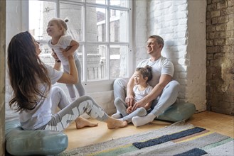Family sitting by window