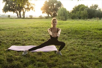 Young woman practicing yoga in park