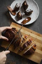 Woman cutting pastry by brownies