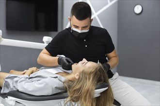 Dentist examining patient