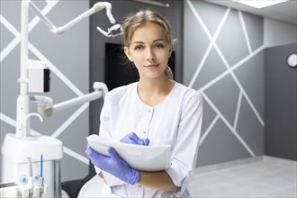 Dental assistant writing notes