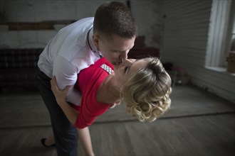 Man dipping and kissing woman