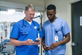 Doctor and nurse using smart phone in hospital