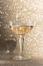 Glass of champagne against glitter background