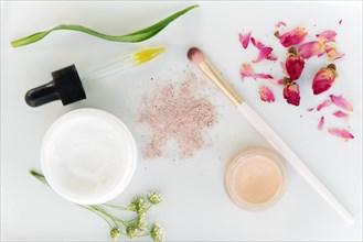 Eyeshadow, skin care products and flowers