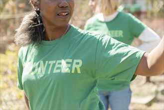 Mature woman volunteer in green t-shirt