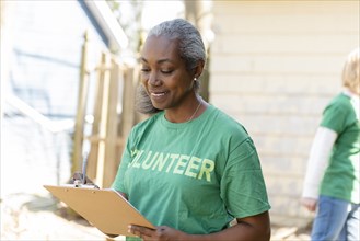 Mature woman volunteer with clipboard