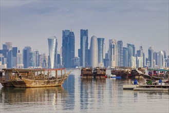 Boats by skyscraper skyline in Doha, Qatar