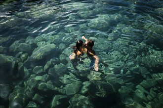Couple kiss while swimming in sea