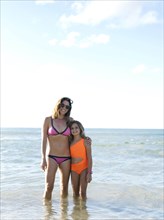 Woman with her daughter on beach