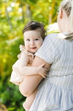 Baby girl being held by her mother