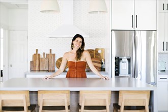Mid adult woman smiling in kitchen