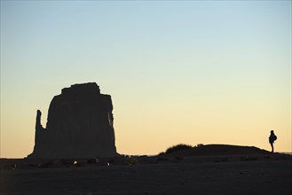 Silhouette of woman by butte in Monument Valley, Arizona, USA