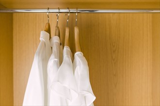 Shirts on clothes hangers in wardrobe
