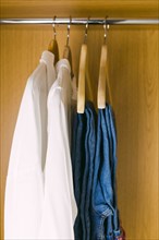 Clothes hanging in wardrobe