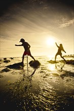 Children exploring tide pools in La Jolla, California